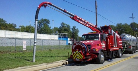 Vac-con removing sand and debris from manhole